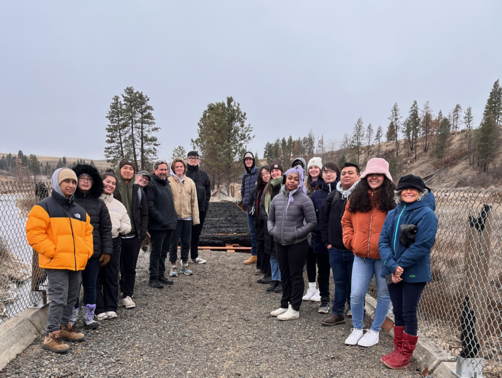 Students witnessing a burned bridge on the Palouse to Cascades Trail near Malden, WA.